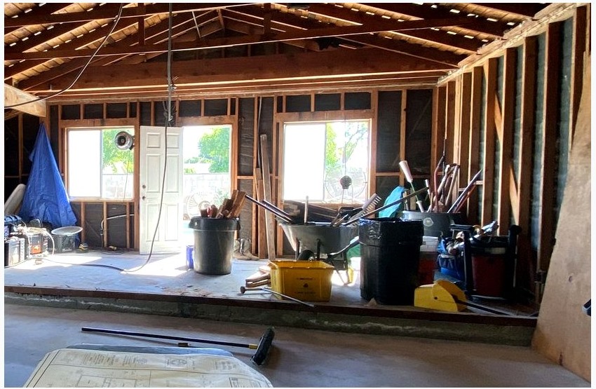 Construction plans on a jobsite table during an ADU planning review